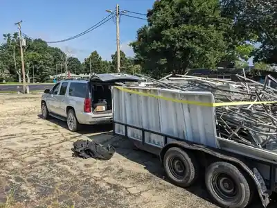 Volunteers loading debris during campus cleanup
