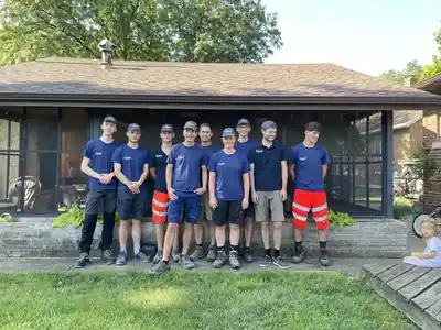 Volunteers gathered on the porch of the brick campus
